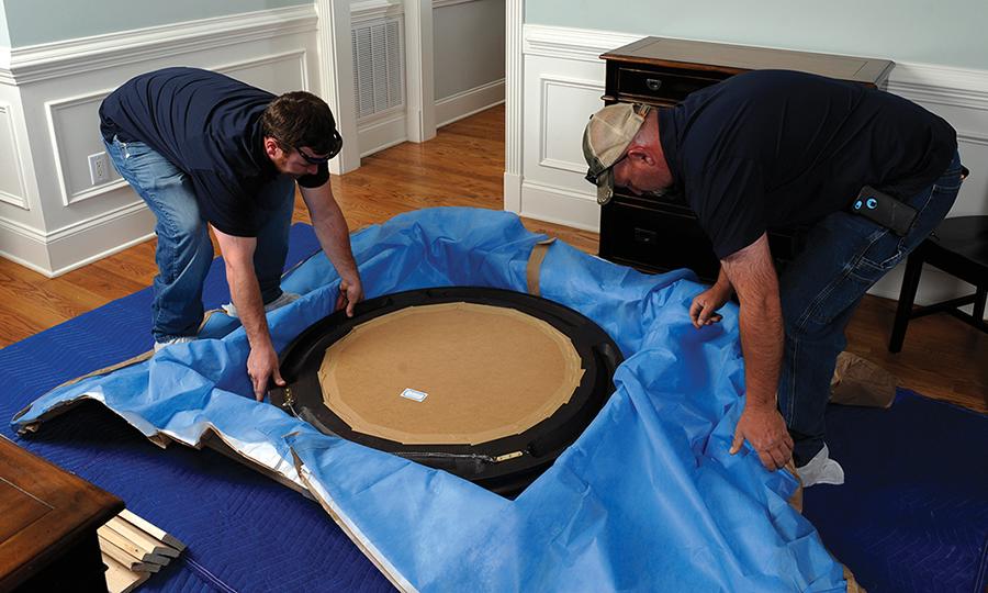 Our movers carefully packing a mirror for our customer.