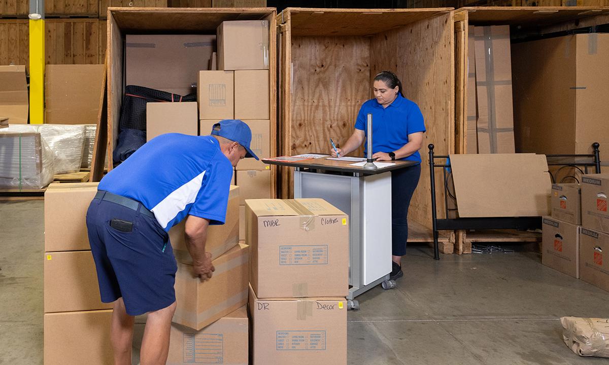 Our movers making boxes in our warehouse.